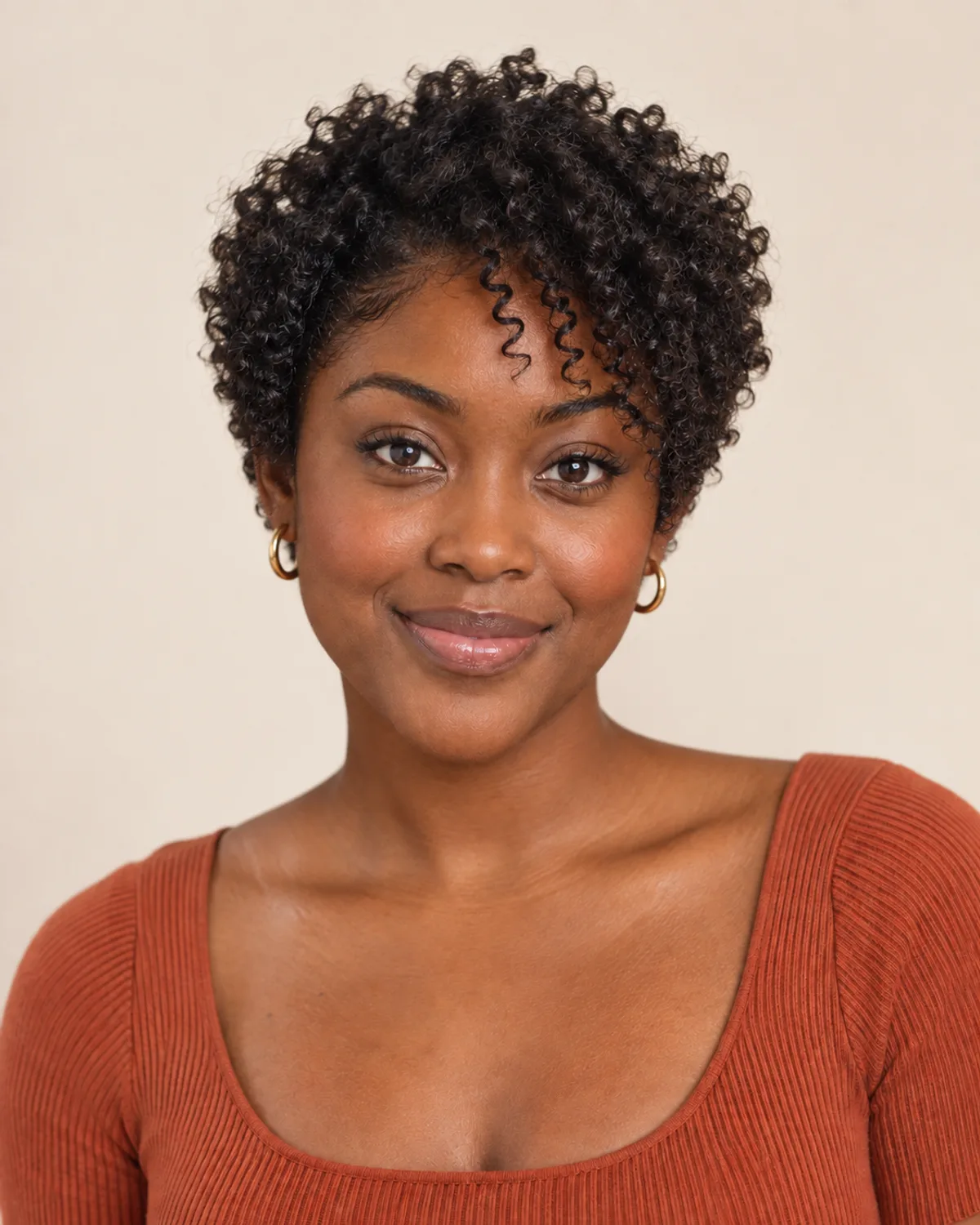 A woman with a short, curly pixie cut.