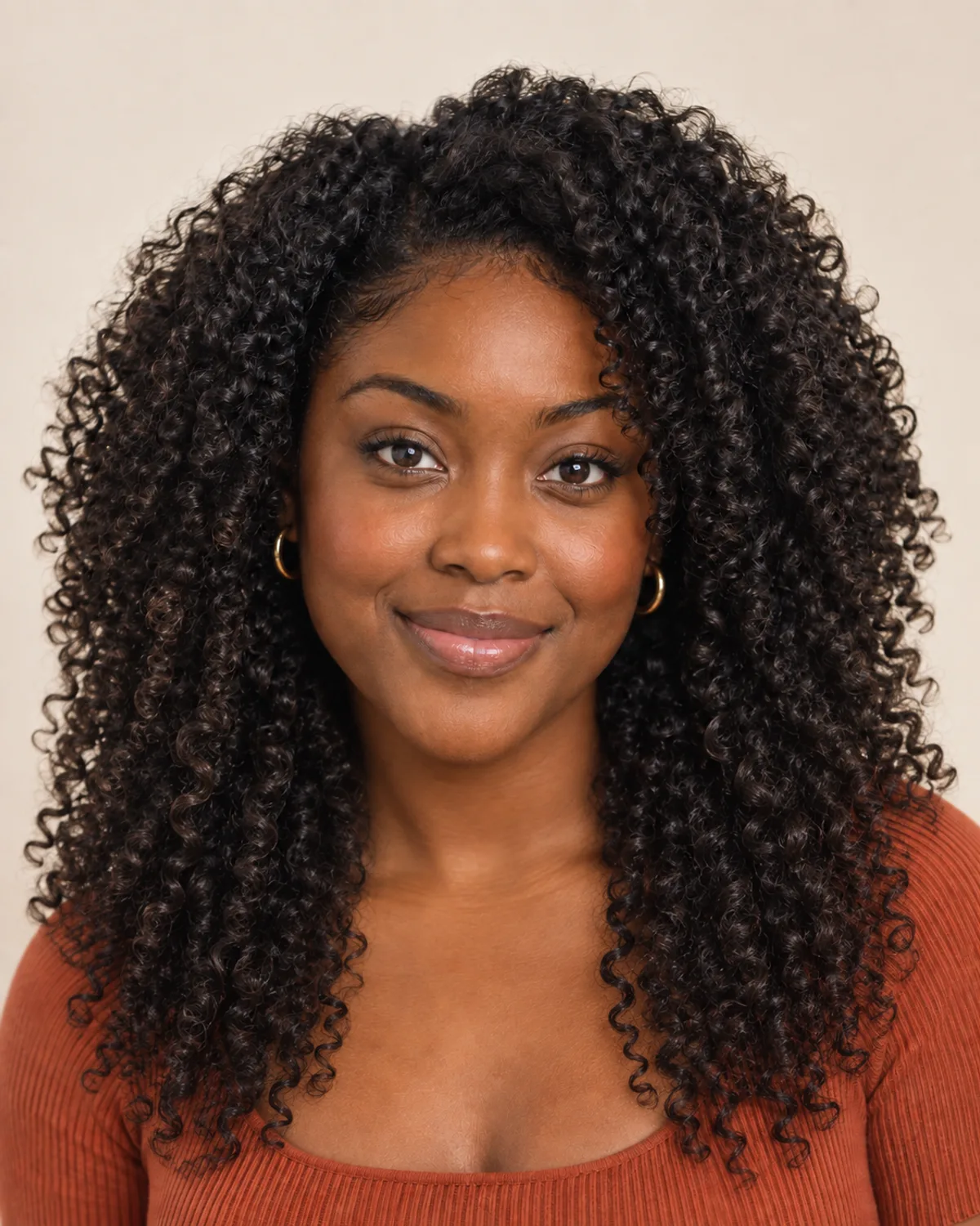 Long, natural black curls falling past the shoulders.