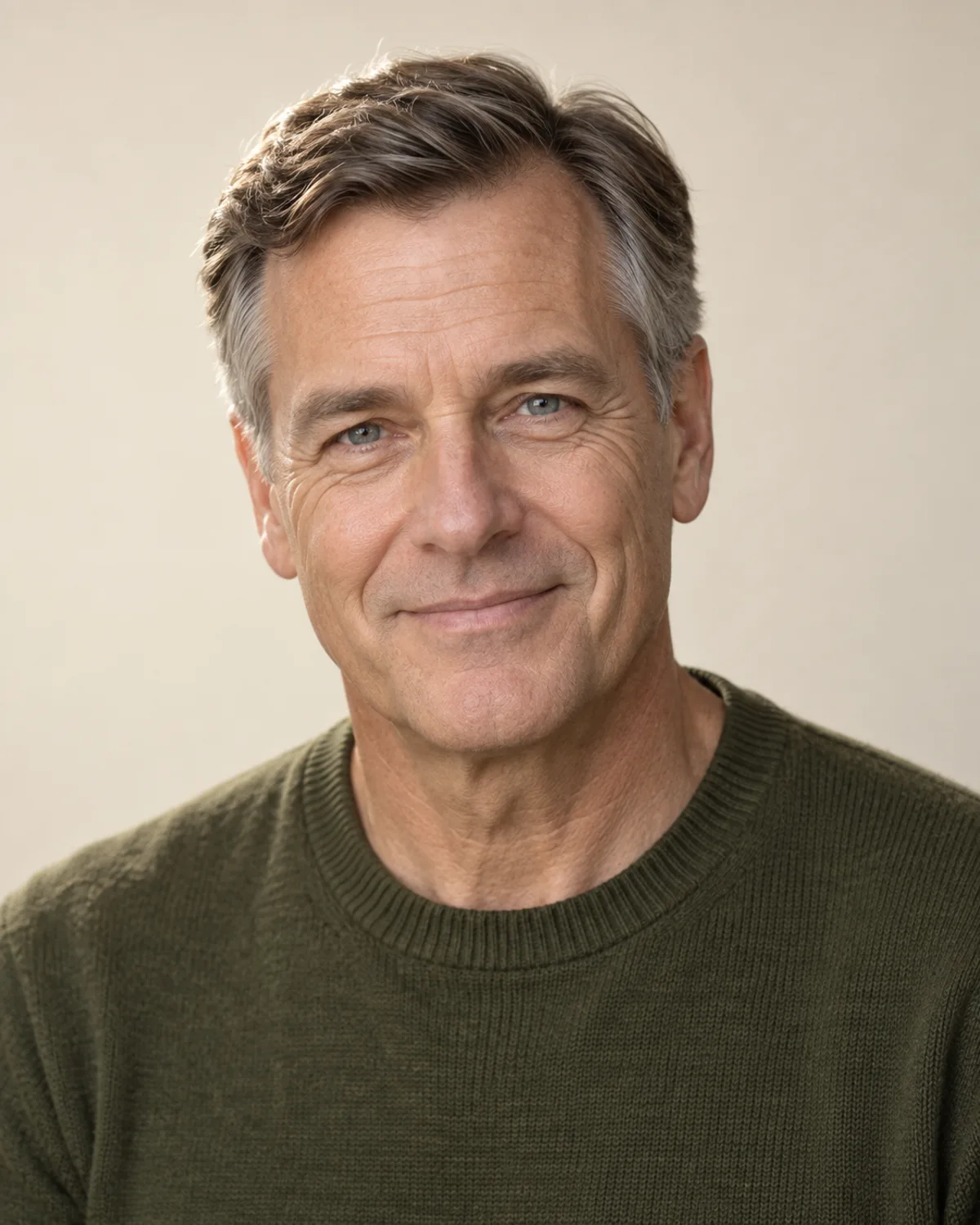 Original clean-shaven portrait with short, graying brown hair before the boxed beard preview
